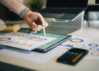 White Label Accounting Services: The Quiet Fix for Firms That Can’t Hire Fast Enough person using stylus on tablet with charts