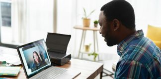 man in blue and white plaid dress shirt using macbook pro