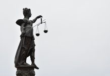 How Time Spent in Custody Can Be Considered at Sentencing A statue of lady justice holding a scale of justice