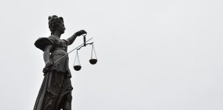 A statue of lady justice holding a scale of justice