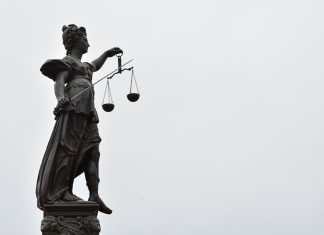 How Time Spent in Custody Can Be Considered at Sentencing A statue of lady justice holding a scale of justice