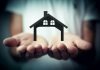 Hands holding a silhouette of a house