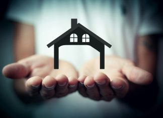 Hands holding a silhouette of a house