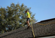 What a Real Roof Inspection Covers, and Why Homeowners Book One Before Storm Season a man on a roof working with a rope