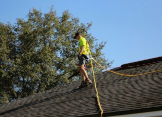 What a Real Roof Inspection Covers, and Why Homeowners Book One Before Storm Season a man on a roof working with a rope