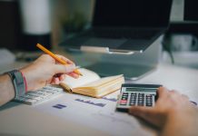 Mental Accounting and the Illusion of Affordability a person sitting at a desk with a calculator and a notebook