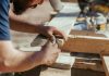 a man working on a piece of wood