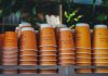 a shelf filled with orange cups sitting next to each other