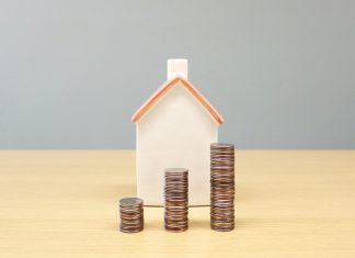 How to check your Housing Loan eligibility before starting your home search? a house and stacks of coins on a table