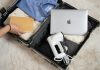 Packing Smart for Long Flights and Travel Layovers An open suitcase with a laptop and other items