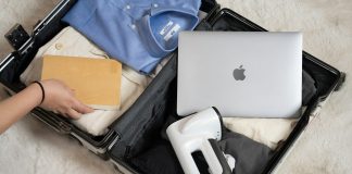 An open suitcase with a laptop and other items