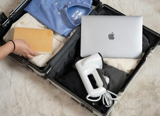 Packing Smart for Long Flights and Travel Layovers An open suitcase with a laptop and other items