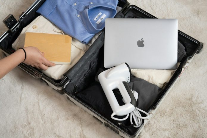 Photo by Neakasa An open suitcase with a laptop and other items