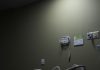An empty hospital bed sits in a dimly lit room.