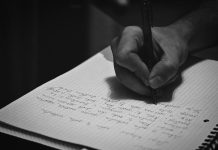 Turn a Dream Fragment Into a Short Creative Writing Exercise A person writing on a notebook with a pen
