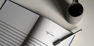 a notebook with a pen on top of it