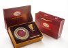 a red box with a gold plate and a golden spoon in it