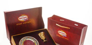 a red box with a gold plate and a golden spoon in it