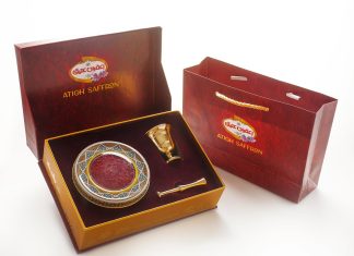 a red box with a gold plate and a golden spoon in it