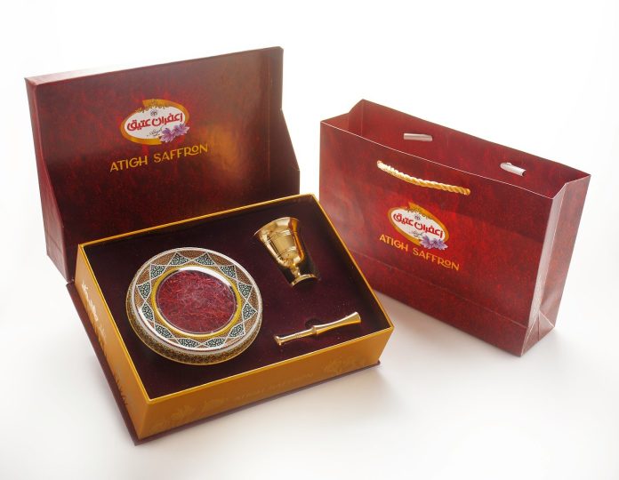 Photo by atigh saffron a red box with a gold plate and a golden spoon in it