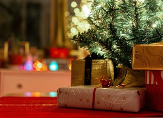brown and red gift box on red textile