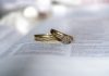 gold diamond ring on white printer paper
