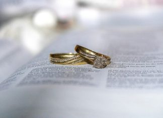 How Fantasy-Film-Inspired Wedding Bands Add Meaning to a Ceremony gold diamond ring on white printer paper