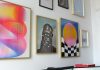 a wall with a bunch of paintings on it