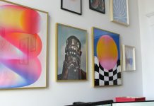 a wall with a bunch of paintings on it