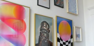a wall with a bunch of paintings on it