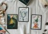 2 black and white cards on white textile