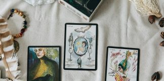 2 black and white cards on white textile
