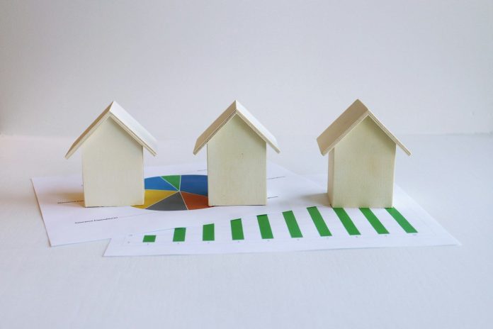 Photo by Artful Homes three small houses sitting on top of a piece of paper