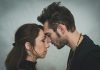 man and woman kissing each other