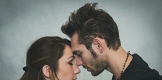 man and woman kissing each other
