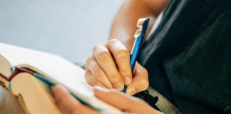shallow focus photo of person writing