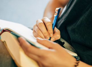 shallow focus photo of person writing