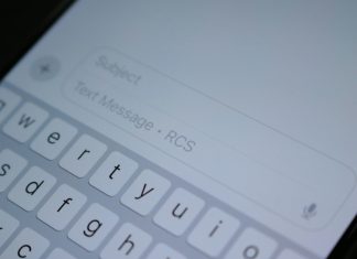 A close up of a cell phone with a keyboard