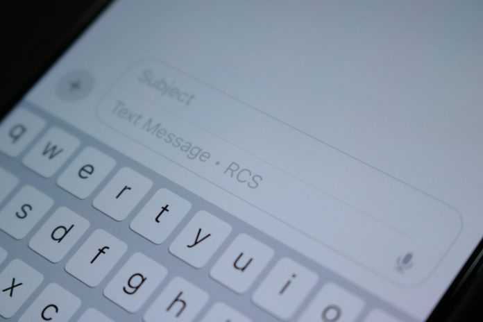 Photo by Samuel Angor A close up of a cell phone with a keyboard