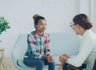 Two women talking in a modern office setting