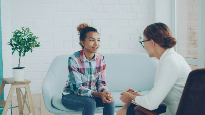 Photo by Vitaly Gariev Two women talking in a modern office setting