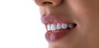 a close up of a woman's mouth with white teeth