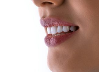 Cosmetic Dentistry and the Psychology of a Smile Makeover: What Porcelain Veneers Really Change a close up of a woman's mouth with white teeth