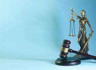 How Do You Prove Liability in a Los Angeles Slip and Fall Case? Lady justice and gavel on a blue background