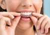 Woman adjusting clear dental aligners on teeth
