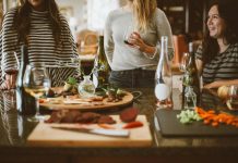 Plan a Remembrance Gathering That Leaves Room for Different Beliefs two woman standing beside woman sitting in front of table