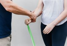 a man and a woman holding a green stick