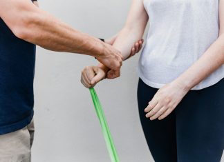 a man and a woman holding a green stick