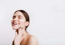 Postbiotic Skincare for Sensitive Skin: A New Direction in Barrier-Friendly Beauty A woman smiles while she holds her hand to her face
