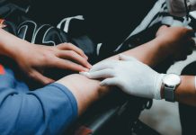 Medicare Liens After a Personal Injury Settlement: How the Reimbursement Math Actually Works person in blue long sleeve shirt holding persons hand